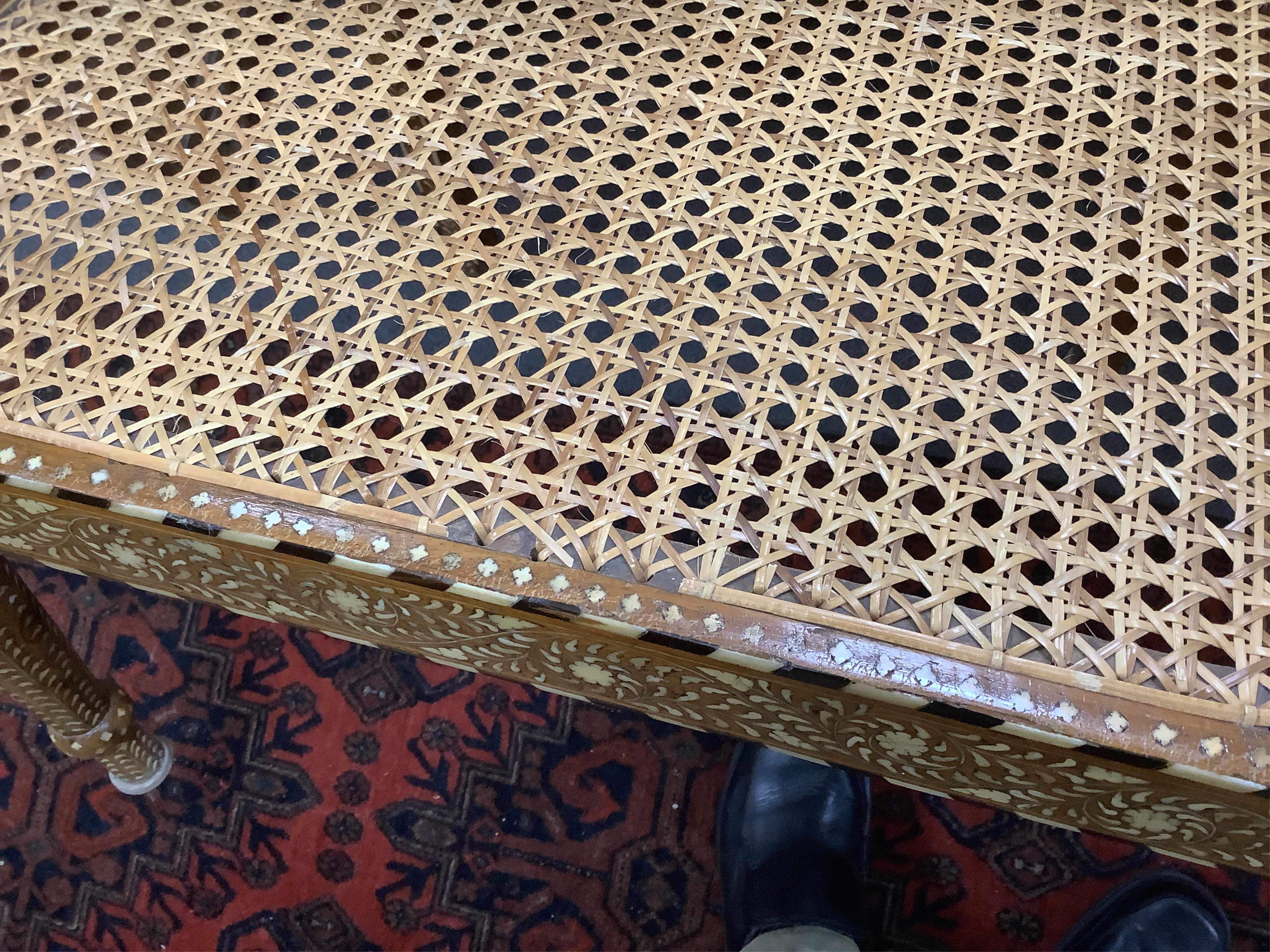 Hoshiarpur, a teak bone inlaid caned settee, width 107cm, depth 48cm, height 97cm. Condition - good